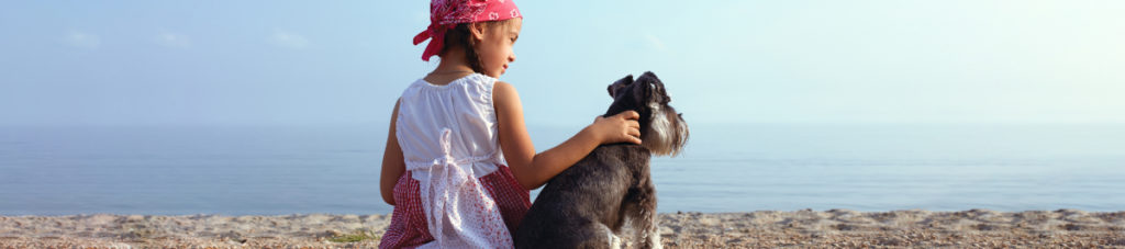 Dog and girl on beach